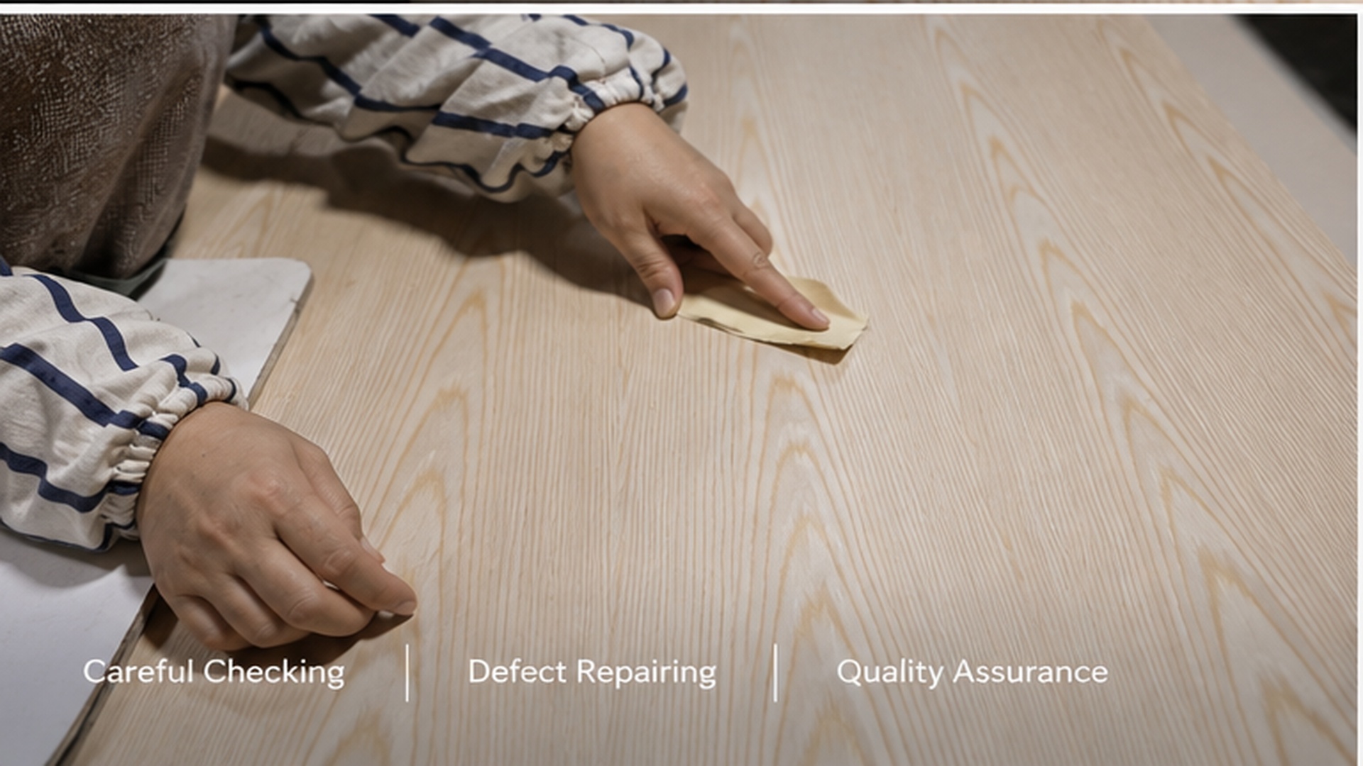 Worker checking and repairing engineered veneer surface quality by hand.jpg